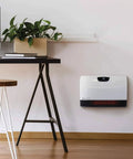 WiFi Infrared Wall Mounted Heater With Remote Touchscreen Digital Thermostat Tip Over Safety Shut Off, installed in a bedroom.