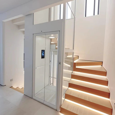 Hassle Free Residential Home Elevator No Pit Or Machine Room For Existing Homes, compact glass lift next to illuminated stairs.