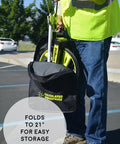 Person holding DigiRoller Plus III 12.5 Inch Electronic Distance Measuring Wheel with backlit display in carrying pack outdoors.