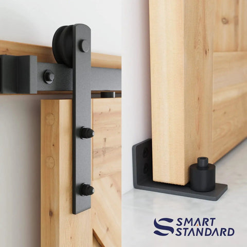 All In One Heavy Duty Sliding Barn Door Hardware Kit Features 11 Foot Track With Whisper Quiet Nylon Rollers For Rock Solid Reliability Smooth Silent Operation Dead Simple Install Durable Alloy Frame No Door Included Matte Black Finish close-up of hardware details and a sliding door.