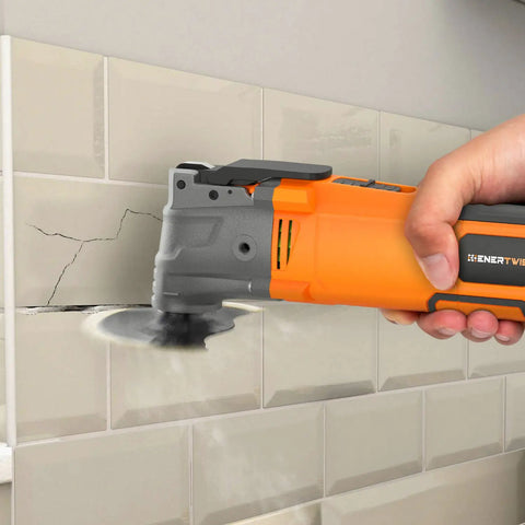 Using Beast Oscillating Multitool Kit 4.2 Amp With 5 Degree Oscillation on tile for demolition, showing auxiliary handle.