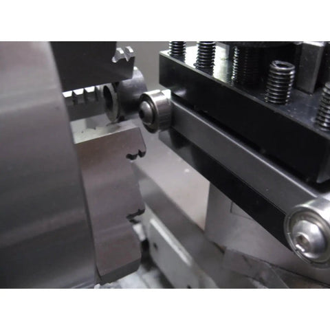 Close-up of lathe centering and truing tool with half inch square tool head, mounted on AXA tool holder in use.