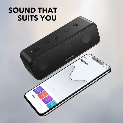 3 Portable Bluetooth Speaker That Delivers Dope Sound With IPX7 Waterproof Build 24 Hour Playtime Titanium Diaphragm Drivers next to phone with EQ app.