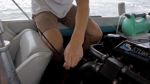 Person using LiquiVac MarinaPro 5000MP 8Qt Fluid Extractor For Boats And Small Engines Oil And Gas Pump on boat engine