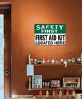 12 By 8 Inch Aluminum Safety First First Aid Kit Located Here Metal Sign on Orange Wall in Room
