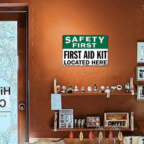 12 By 8 Inch Aluminum Safety First First Aid Kit Located Here Metal Sign on Orange Wall in Room