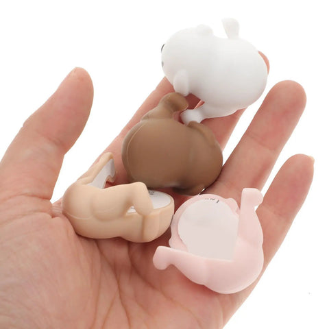 Hand holding Silicone Corner Protectors Cartoon Puppy Design 8 Pack Edge Guards for tables, desks, cabinets, and furniture safety.