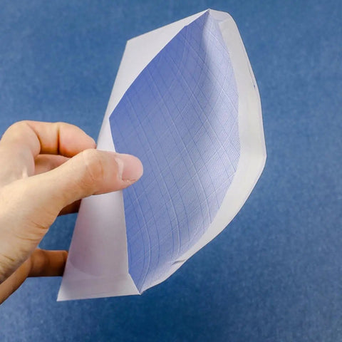 Hand holding 100 Pack White Privacy Pattern Envelopes Self Sealing Mailers showcasing interior privacy pattern detail