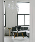 French Country Crystal Pendant Light With White K9 Crystals And Wrought Iron Frame E12 Candle Style in a living room.