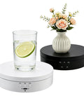 Motorized Rotating Display Stand With Electric Turntable For Products Photography Display Jewelry Watch 3D Models Cake Collectibles Featuring Manual Speed Adjustment And Multiple Angular Views In Sleek Matte Finish with glass and flowers.