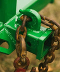 Green tractor hitch with chain, part of Dual Design Gooseneck Tractor Trailer Hitch With Hay Bale Spear Charcoal Frame Two Inch Receiver Mount