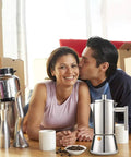 Heavy Gauge Stainless Steel Stovetop Espresso Maker And Legit Italian Moka Pot for 4 Cups beside couple enjoying coffee at home.