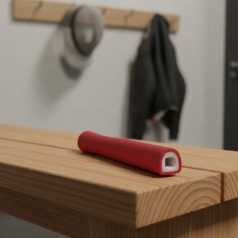 Red fencing handle replacement grip for foil epee cutlass on bench, lightweight ergonomic design, training or competition grip.