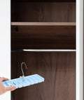 Sleek Belt And Tie Organizer Rack With Foldable Hooks Designed For Compact Closet Spaces Kick Your Wardrobe Into High Gear Keep Accessories Neatly Secured Easy Install Blue shown being installed in a wooden closet.