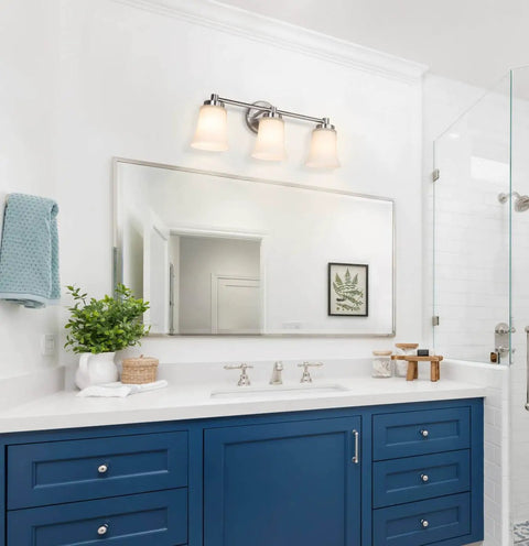 Bathroom with Dope Modern Brushed Nickel Vanity Light With Glass Shades, 3-Light Bath Bar, mounted above a mirror and blue vanity.