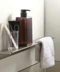 Choreograph 14 Inch Floating Shower Shelf in Anodized Brushed Nickel with toiletries and towel, sleek modern bath accessory