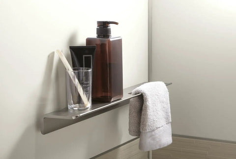 Choreograph 14 Inch Floating Shower Shelf in Anodized Brushed Nickel with toiletries and towel, sleek modern bath accessory