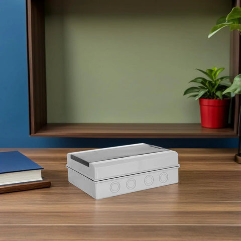 Rugged Weatherproof Electrical Distribution Box With Breaker Panel, white plastic, designed for outdoor wiring setup on a wooden desk.