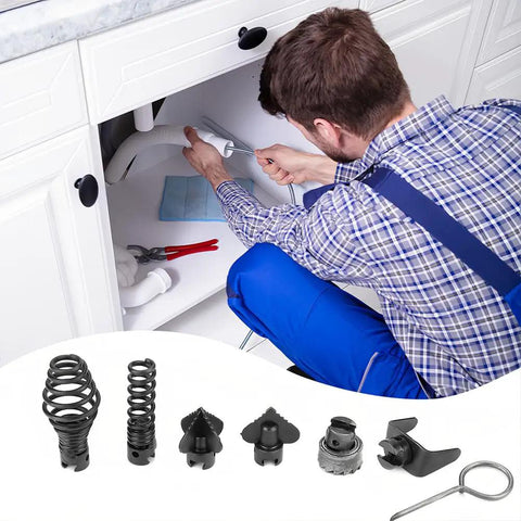 Man using electric drain cleaner cutter head kit under kitchen sink; tools and attachments visible for clogs.