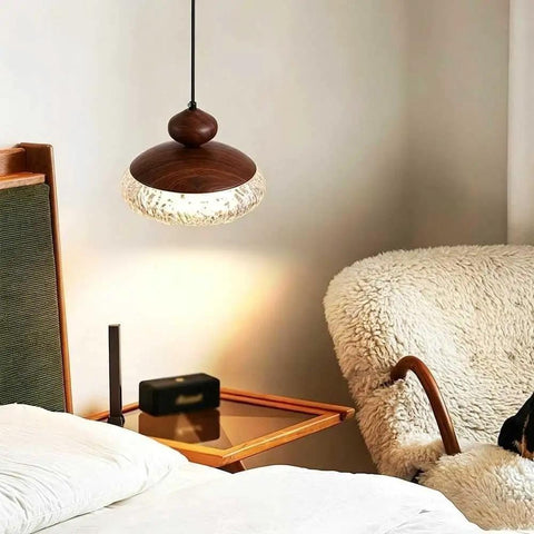 Wood Grain Pendant Light, 3 Color LED Resin Hanging Fixture for Bedroom above a cozy bed with textured shade.