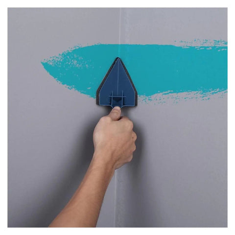 Hand using triangle cutter on wall to paint sharp edges, part of Premium 5 Piece Wall Paint Roller Brush Set Heavy Duty Rollers.