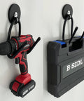 Four Pack Magnetic Garage Hooks Heavy Duty Tool Organizer Rack For Power Tools Garden Tools Hose Pegboard And Workshop Indoor Outdoor Hanging No Drill Required Industrial Strength Magnets Hold Up To Ten Pounds showing installed drill and toolbox.