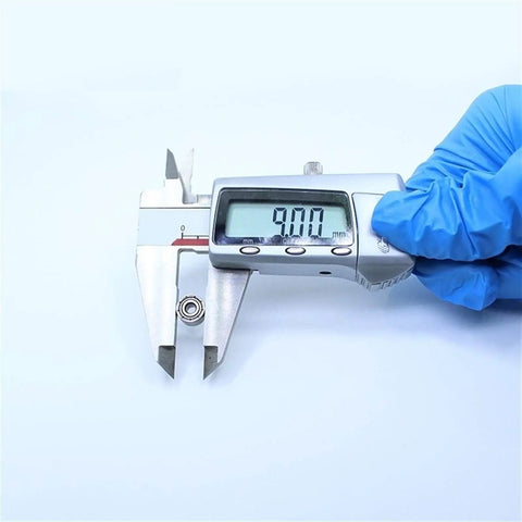 Measuring Heavy Duty 603ZZ And 603Z Miniature Ball Bearings Featuring Super Smooth ABEC-1 Ratings with digital caliper at 9mm.