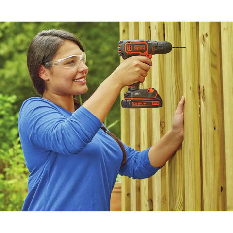 Woman using 20V Max Cordless Drill Driver Kit With Battery And Charger Includes Double Ended Bit Lightweight 3.15 Lbs 11 Position Clutch For Precision 0 To 650 RPM Delivers 115 Lbs Of Torque For Wood Metal Plastic Projects Your Go To Power Tool on wooden fence