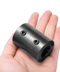 Three Quarters Inch Bore Shaft Coupling One And A Half Inch Outer Diameter Two Inch Length Black Oxide Plated Steel Rigid Coupler With Two Set Screws Motor Wheel Coupler Beefy Industrial Grade Part For Heavy Duty Power Transmission in hand