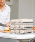 54 Egg Rolling Organizer for Refrigerator with 3 Layers, Clear Egg Storage Box with Lid on kitchen counter