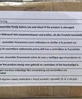 Warning label on a cardboard box with assembly instructions in multiple languages.