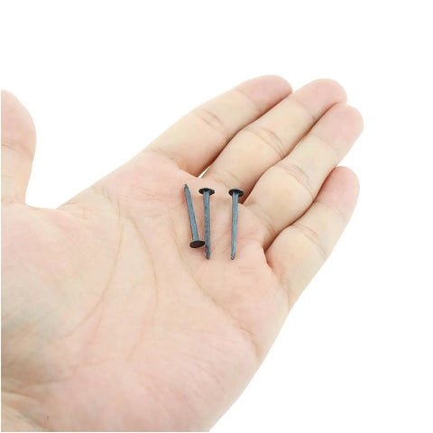 Super Tough 470 Pc Black Round Head Metal Tacks For Shoe Repair Upholstery And Craft Projects held in hand, showcasing 25mm length.