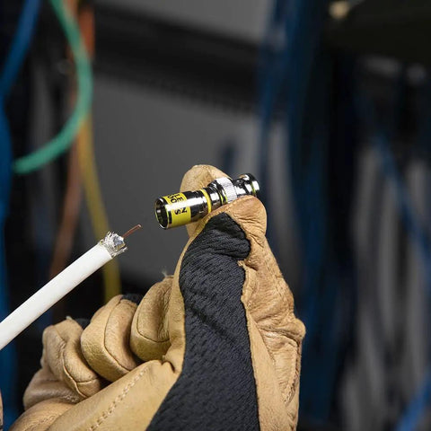 Installer holding Universal BNC Compression Coax Connector For RG6 And RG6 Quad Shield Cables, preparing for installation.