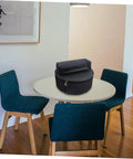 Waterproof Oxford Cloth Drum Backpack With Dead Easy Padded Straps And Adjustable Instrument Gig Bag on a table in a modern room.