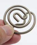 Hand holding a circular metal component for Electronic Exhaust Actuator Valve Spring Repair Kit Plug And Play Replacement For 2015 To 2022 Dodge Challenger Charger And Porsche Models A3 A6 A7 A8 Q2 Q3 A5 TT With Precise Servomotor Control For Smooth Engine Performance.