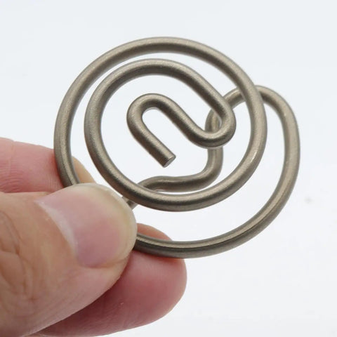 Hand holding a circular metal component for Electronic Exhaust Actuator Valve Spring Repair Kit Plug And Play Replacement For 2015 To 2022 Dodge Challenger Charger And Porsche Models A3 A6 A7 A8 Q2 Q3 A5 TT With Precise Servomotor Control For Smooth Engine Performance.