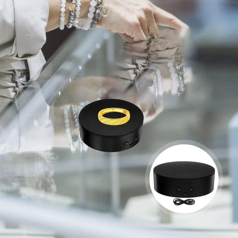 Electric Rotating Jewelry Display Stand showcasing a gold ring on a sleek black turntable with USB power.