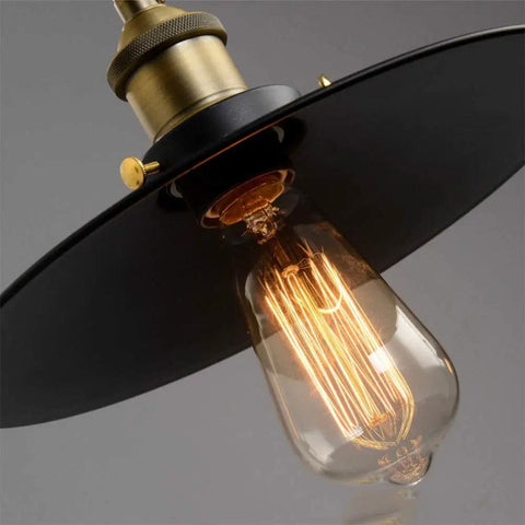 Close up of Drop Dead Modern Industrial Chandelier 3 Light Retractable Pulley Pendant bulb with a brass socket and black shade.