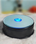 Fieifi Motorized Rotating Led Light Display Base For Crystals And Glass Art, 4.75 inch black turntable with blue light.