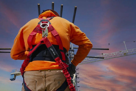 Worker wearing Premium EagleLite Harness With Tongue Buckles And 3 Steel D Rings For All Day Fall Protection On Construction And Industrial Jobsites.