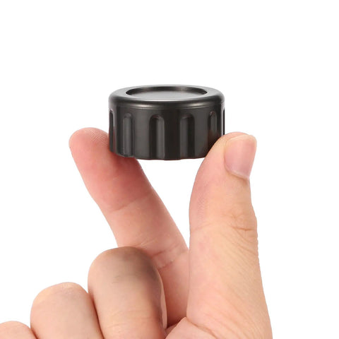 Close-up of a hand holding a black plastic cap, not related to 12 Pack Brass Garden Hose End Caps With Washers Three Quarter Inch Female End Caps.