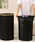 Kick Clutter To The Curb With This Slick Collapsible Storage Bin And Lid Premium Oxford Fabric Organizer Basket Build Ideal For Laundry Towels Books Plus Daily Gear Seamless Household Maintenance That Settles Perfectly In Any Room. Two black collapsible bins showcased, one with a bamboo lid and the other filled with bottles.