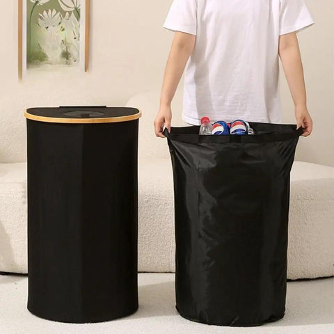 Kick Clutter To The Curb With This Slick Collapsible Storage Bin And Lid Premium Oxford Fabric Organizer Basket Build Ideal For Laundry Towels Books Plus Daily Gear Seamless Household Maintenance That Settles Perfectly In Any Room. Two black collapsible bins showcased, one with a bamboo lid and the other filled with bottles.
