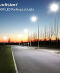 LED Parking Lot Light 150W, 100W, 75W Adjustable illuminating a parking lot at dusk