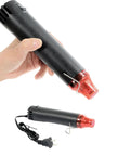 Person holding Crafts Heat Gun 110V 300W Handy Hot Air Tool with Ultra Long 3.28Ft Cord and Stand for PVC Shrink Wrap Embossing.