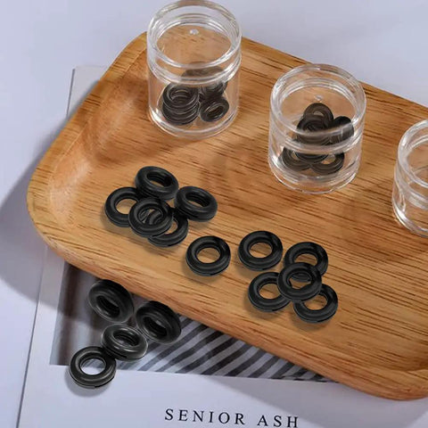 Black Eyeglass Frame Grips Hinge Tighteners Pack Of 10 displayed on wooden tray in clear containers