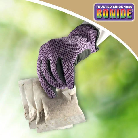 Gloved hand holding Mouse Magic Scent Packs For Indoor And Outdoor Rodent Control 4 Ready To Use Packs That Repel Mice
