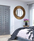 Bedroom with modern decor featuring grey double doors and circular mirror
