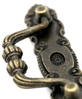 Close-up of Set Of Four Vintage Brass Bail Pulls For Drawers Cabinets And Dressers With Antique Distressed Finish Drop Handle Design