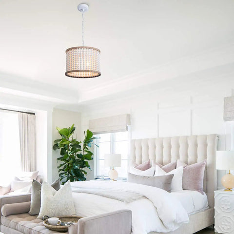 Bohemian Wood Beaded Chandelier Three Light Pendant With White Finish in styled bedroom with tufted bed and cozy cushions